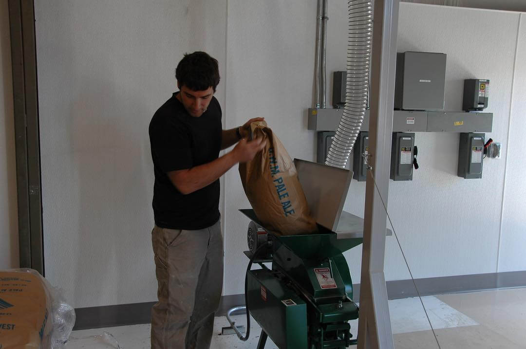 #tbt to Curt Plants milling in @goodlifebrewing’s first bag of malt in 2011 helping create our first beer! Thanks for paving the way for us, Curt. #unforgettable