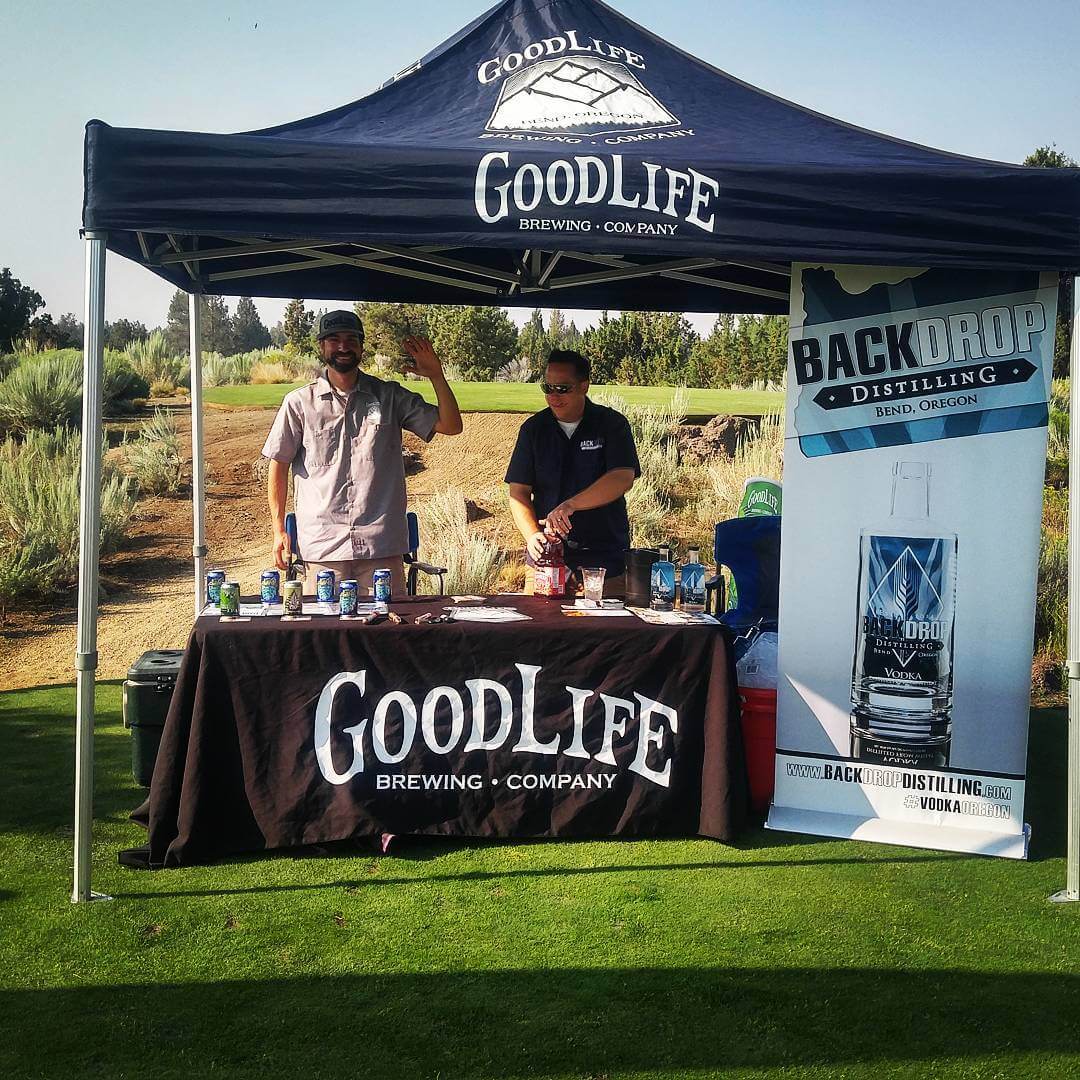 Happy guys pouring some refreshing beverages at the Ghost Tree Golf Tournament!