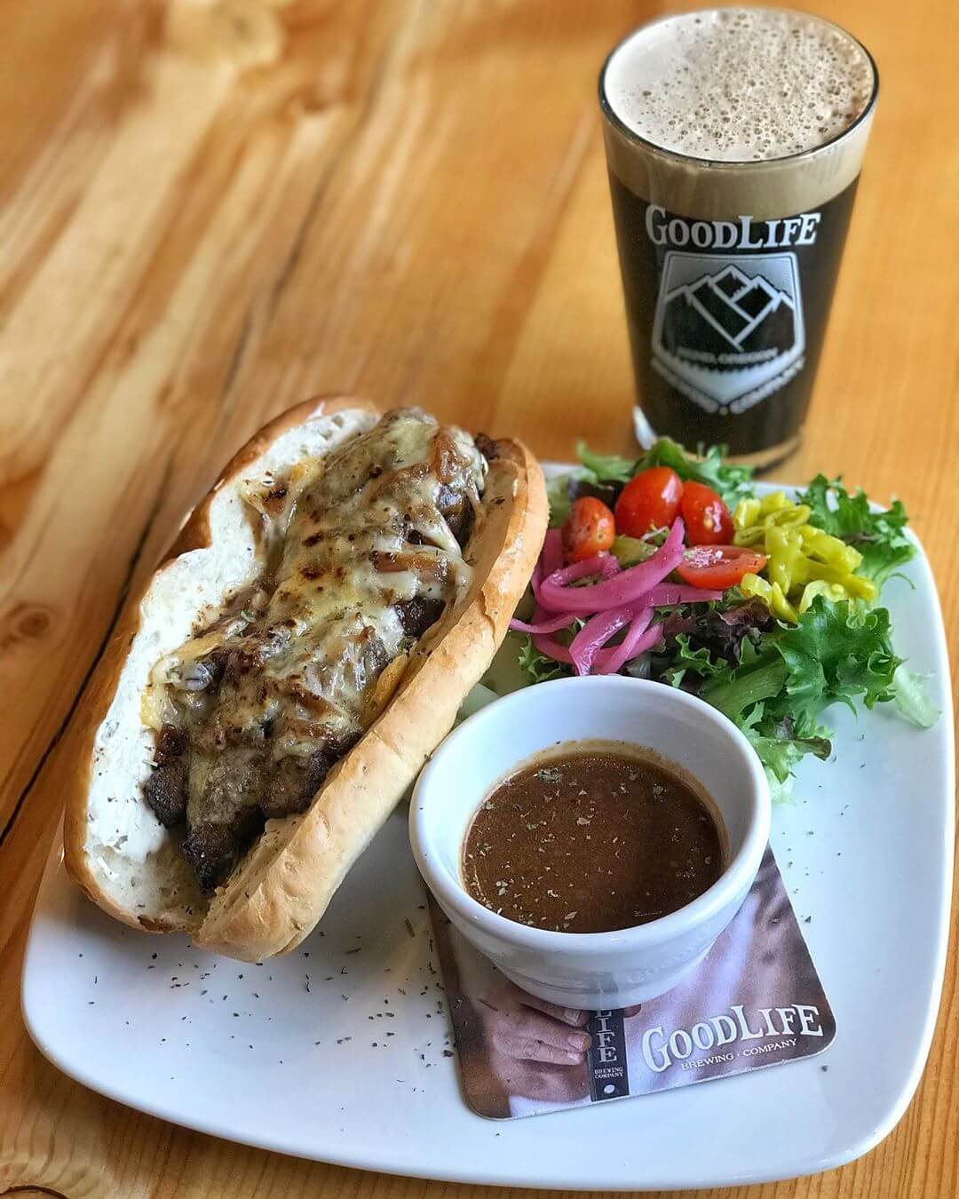 As the seasons change, so does our food menu in the pub! Our head chef wanted to highlight one of his new favorite items on the menu which is a Flank Steak Dip with roasted flank steak, caramelized onions, beer cheese, havarti, house au jus on spent grain with a healthy salad paired with a pint of NITRO Pass Stout! Now what could be better than that on a fall day! #goodlifebrewing